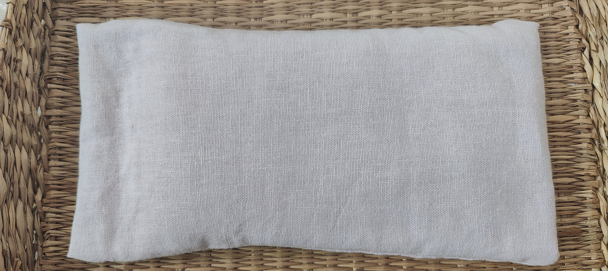 Lilac eye pillow on a woven surface